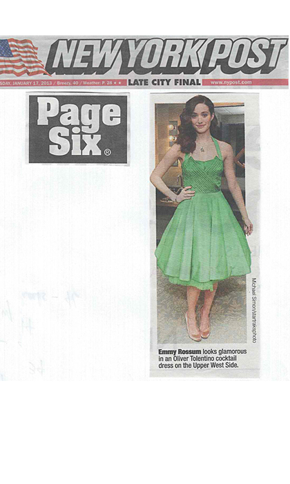 Newspaper clipping of woman in green dress
