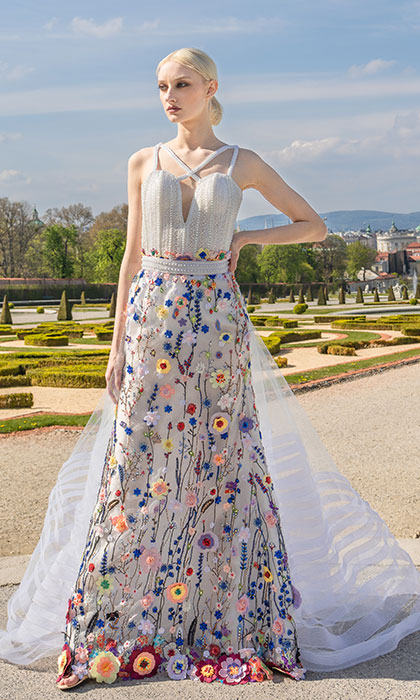 Woman in a white and floral gown with white tulle train