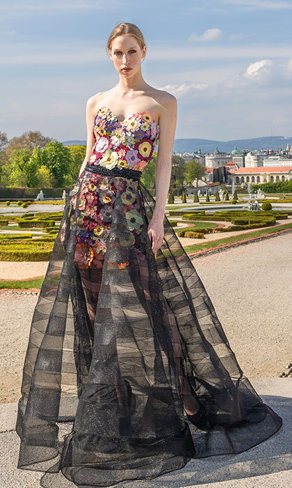 Woman in a multicolored floral corset and skirt, and black tulle overskirt