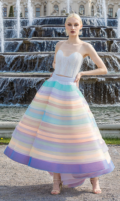 Woman in a white corset and multicolored stripe ball skirt