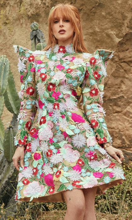 Magazine page of a woman in a multicolored floral dress