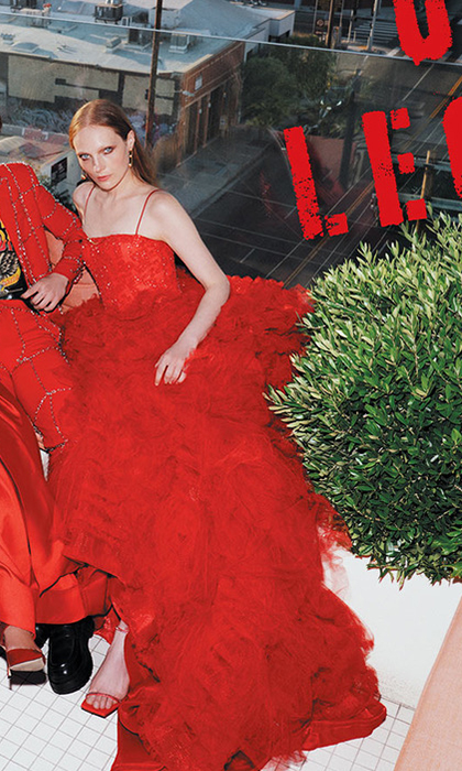 Magazine page of 2 female and 1 male models sitting in red outfits