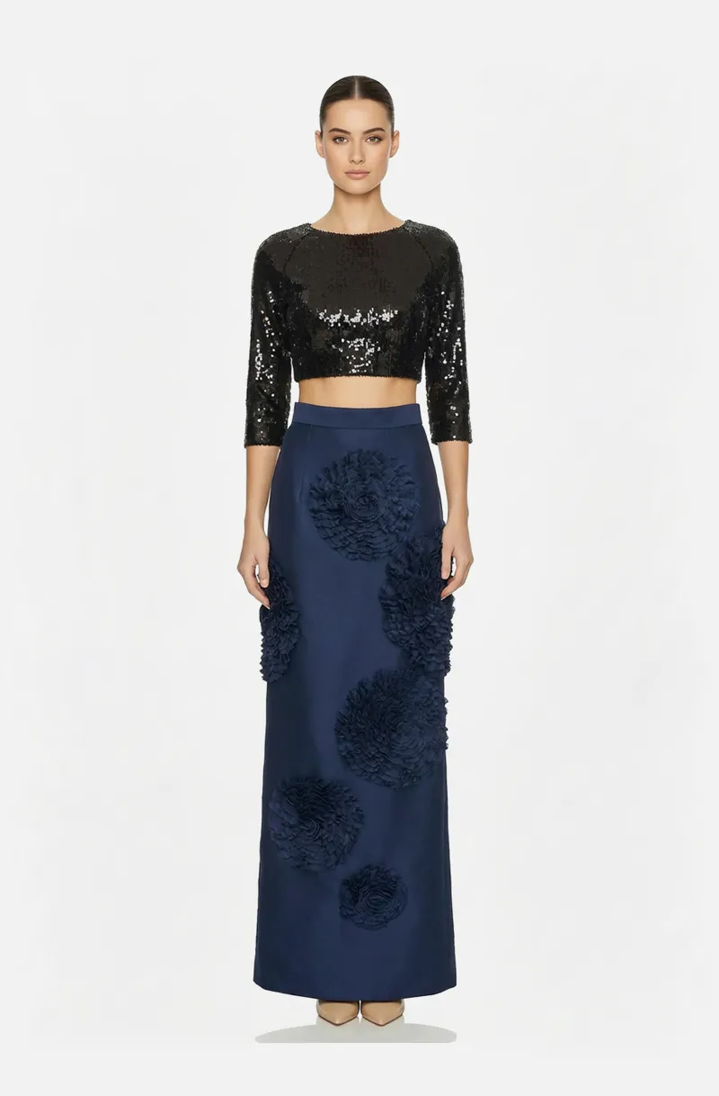 Front view of a woman in a Black sequin crop top and navy Mikado long skirt with hand-stitched rosette accents 23, image 1