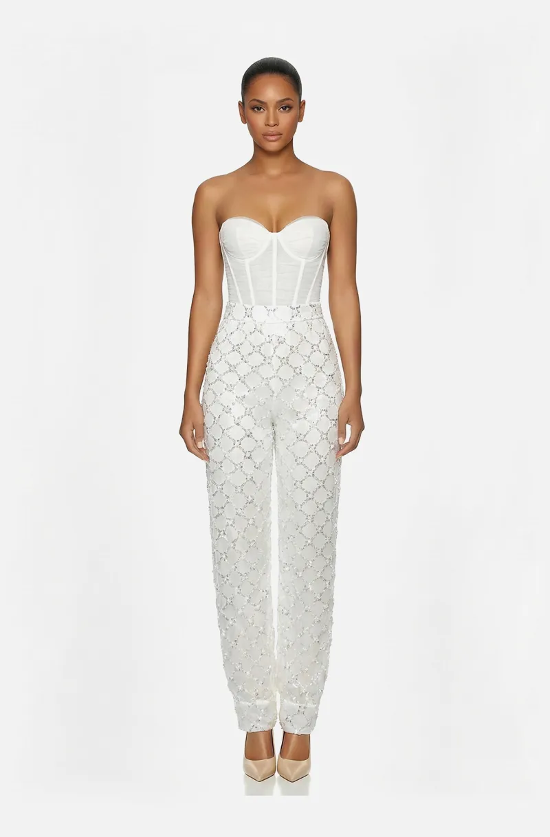 Front view of a woman in an Off-white two-piece ensemble of hand-draped tulle corset with beaded harem pants 41, image 1