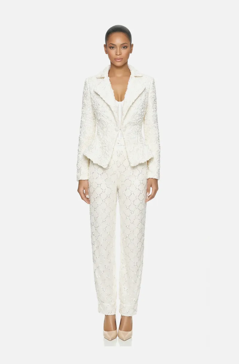 Front view of a woman in an Off-white three-piece ensemble of hand-draped tulle corset, beaded harem pants, and ribbon floral-patterned jacket 42, image 1