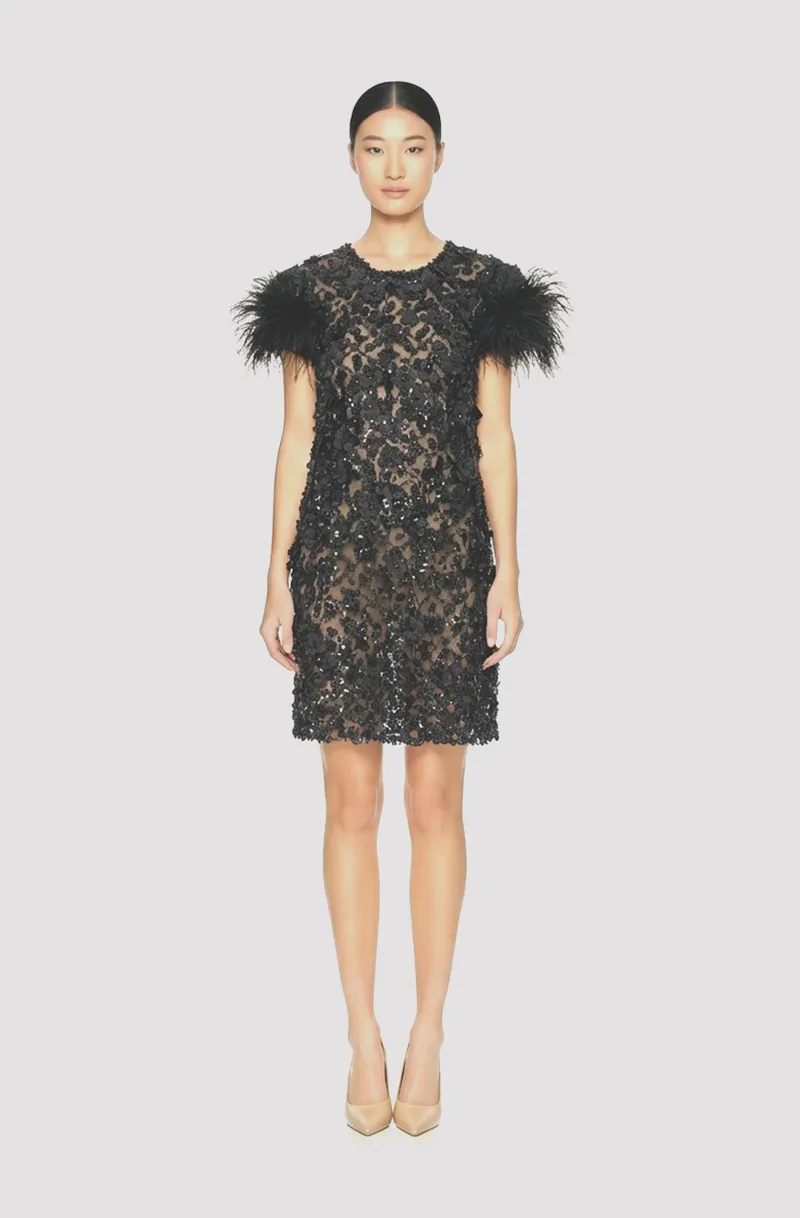 Front view of a woman in a Black hand-beaded sheer mini couture dress with 3D floral appliqués and ostrich feather cuff sleeves 70, image 1