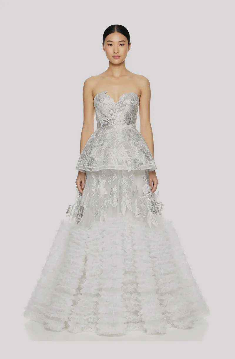 Front view of a woman in an Off-white, two-piece silver 3D lamé floral couture ensemble with a structured corseted top and a layered ruffled tulle ball skirt 38, image 1