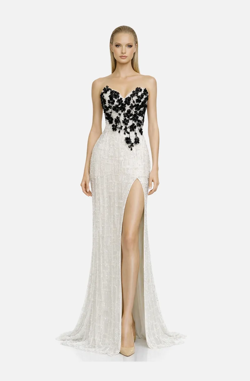 Front view of a woman in a White fully beaded column gown with sweetheart neckline embellished with black beaded floral appliqué and featuring high side slit 45, image 1