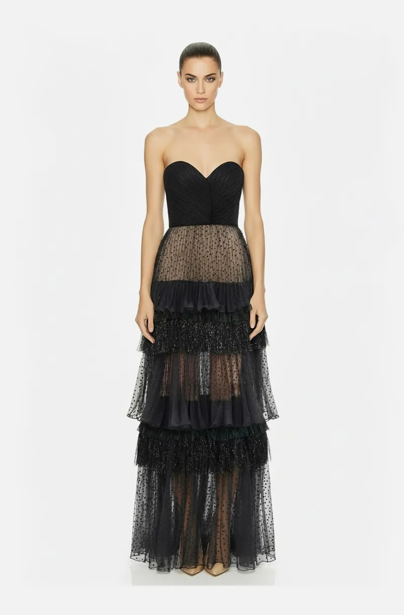 Front view of a woman in a Black strapless corseted gown with hand-draped bodice & dotted sheer organza tiered skirt accented w/ metallic fringe 52, image 1