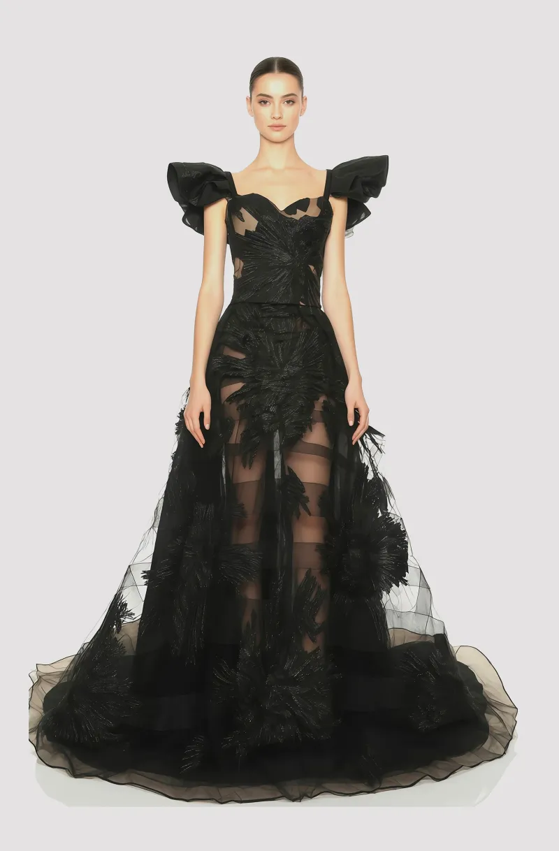 Front view of a woman in a Black two-piece floral lamé couture ensemble of corset with winged sleeves and a sheer tulle ball skirt accented with concentric horsehair strips 55, image 1