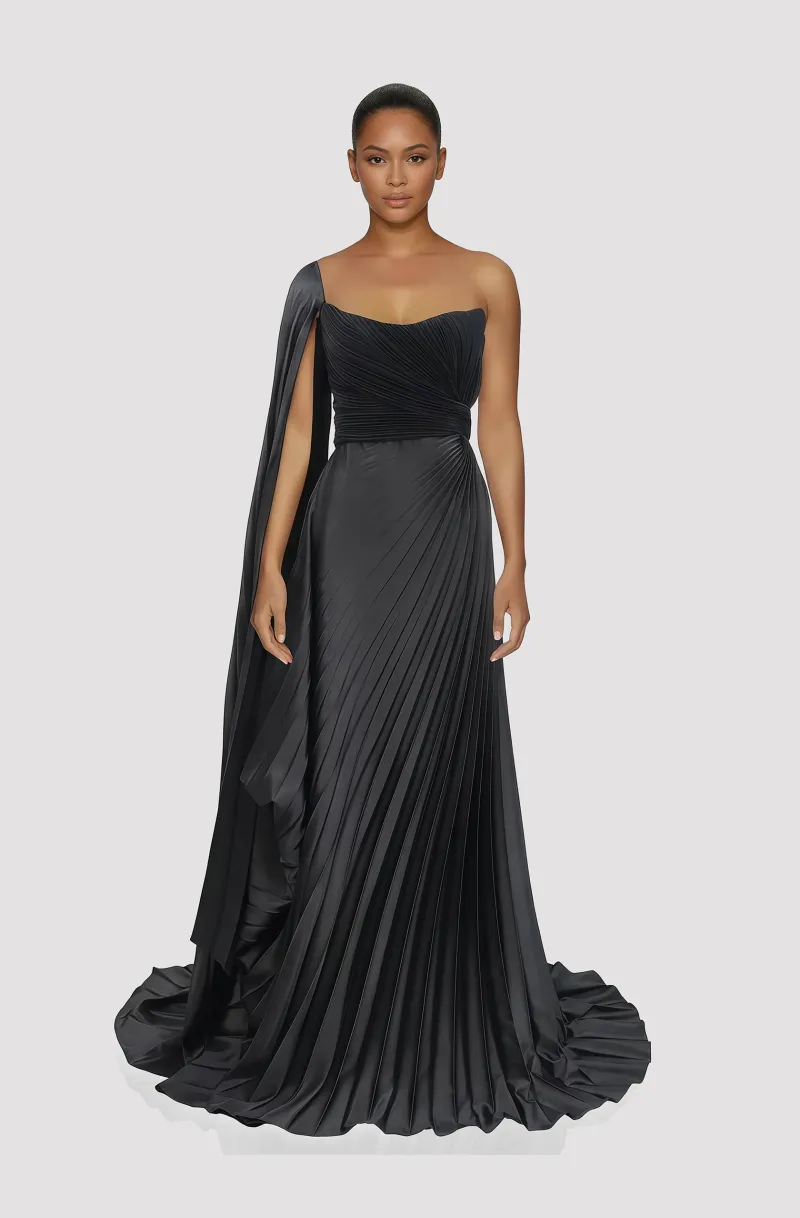 Front view of a woman in a Black satin gown with balconette neckline draped corset and electric-pleated skirt and matching one-shoulder sleeved cape 56, image 1