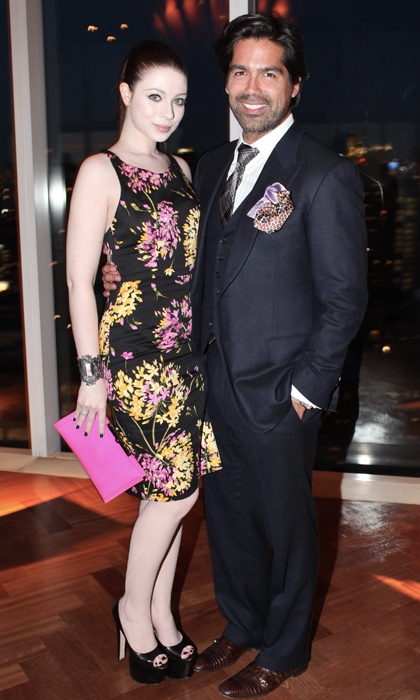 A man in a suit, and a woman in a floral printed dress