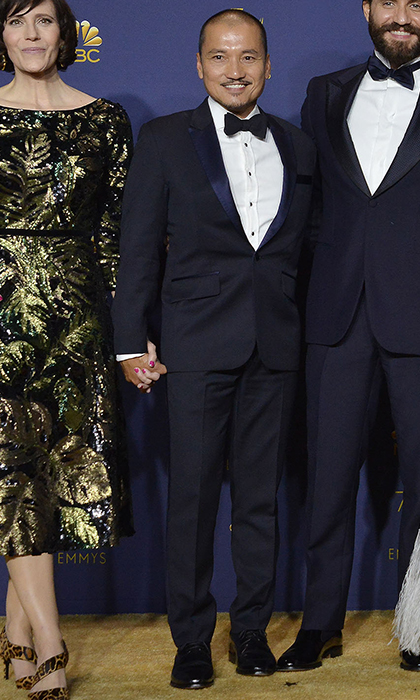 1 woman in a gold dress and 2 men in blue tux