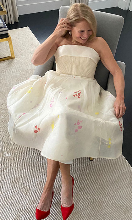 Woman in an off white dress sitting down